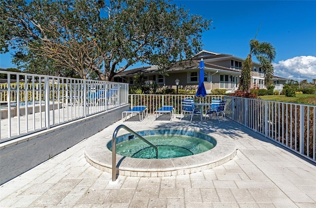 view of pool with a patio area and a hot tub