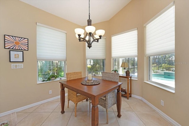 dining room with light tile patterned flooring, plenty of natural light, and an inviting chandelier