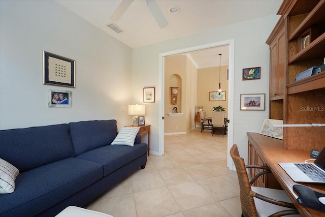 living area with visible vents, baseboards, ceiling fan, vaulted ceiling, and light tile patterned flooring