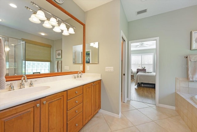 ensuite bathroom with double vanity, visible vents, a sink, and tile patterned floors