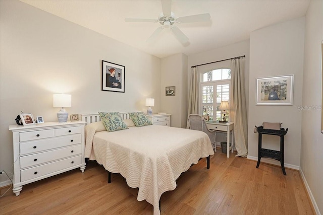 bedroom with a ceiling fan, baseboards, and light wood finished floors