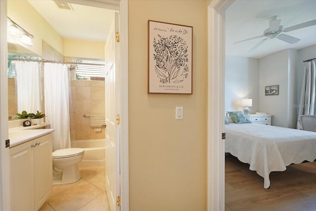 bedroom featuring light tile patterned floors, ceiling fan, visible vents, and connected bathroom