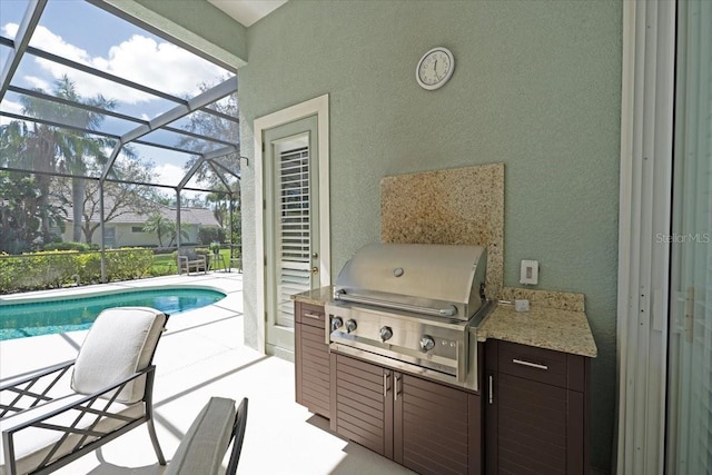 view of patio / terrace with glass enclosure, an outdoor pool, and area for grilling