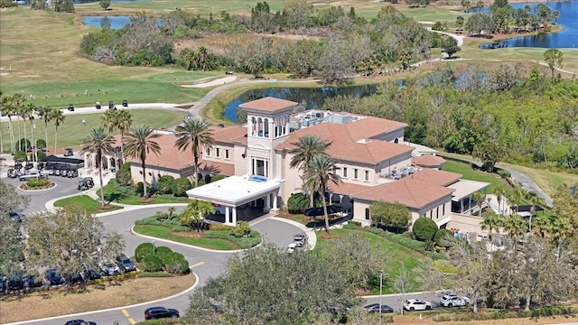 birds eye view of property with a water view and golf course view