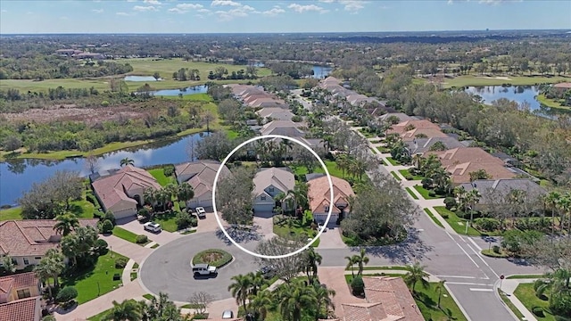 bird's eye view featuring a water view and a residential view