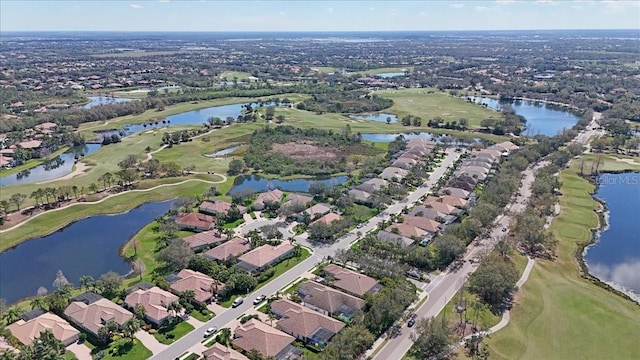 drone / aerial view with a water view, a residential view, and golf course view