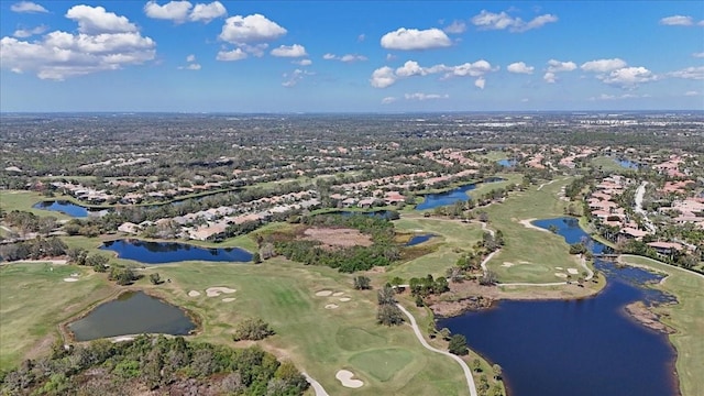 birds eye view of property with a water view and golf course view