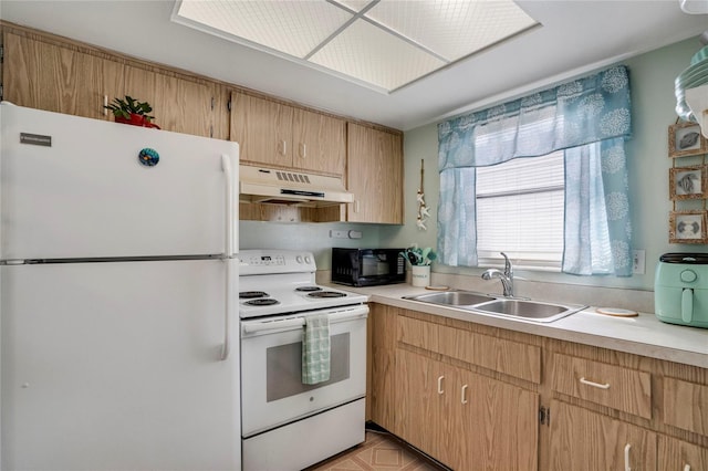 kitchen featuring white appliances, under cabinet range hood, light countertops, and a sink