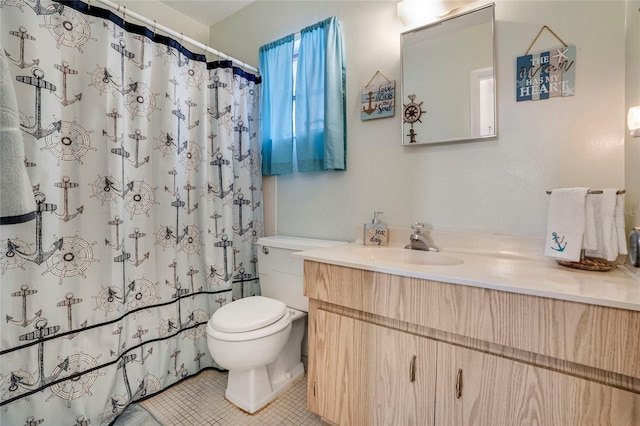 bathroom with toilet, tile patterned floors, and vanity