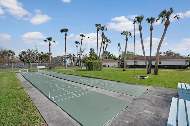 surrounding community featuring shuffleboard and a yard