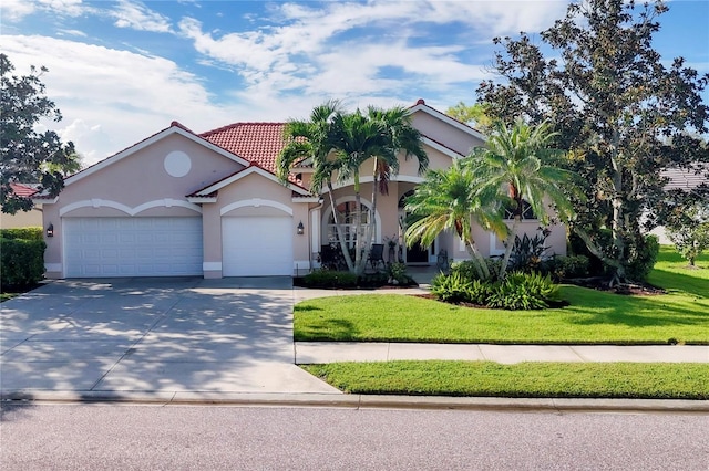 view of front of house featuring a front lawn and a garage