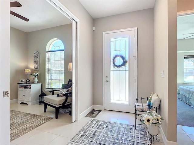 tiled foyer with ceiling fan