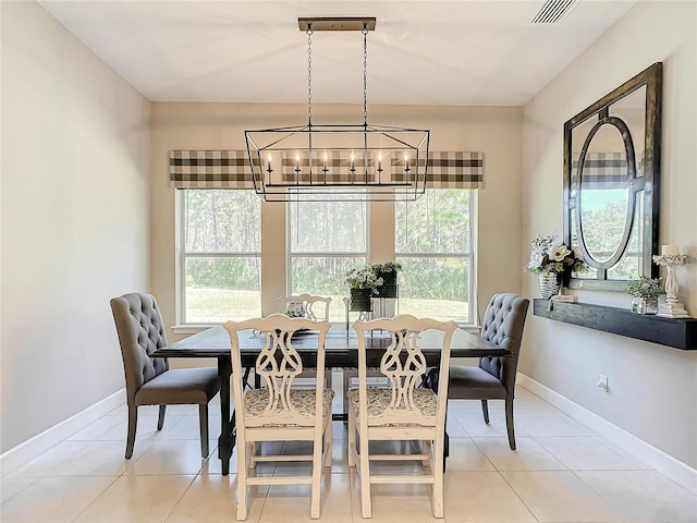 tiled dining area featuring a wealth of natural light and a chandelier