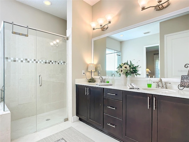 bathroom with vanity and a shower with door