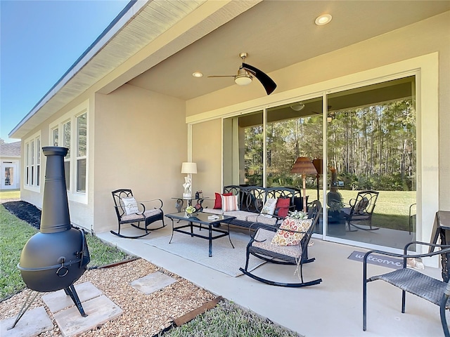 view of patio featuring an outdoor living space and ceiling fan