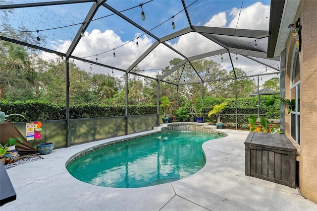 view of pool featuring pool water feature, a patio area, and glass enclosure