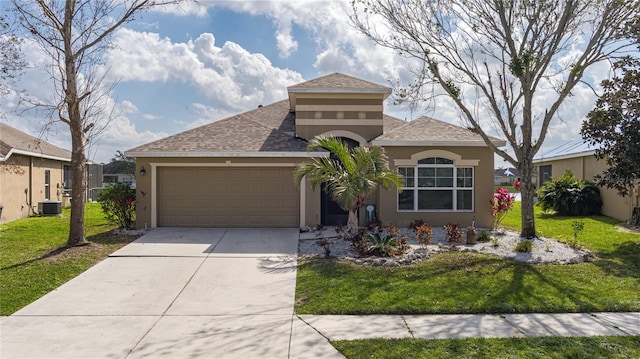 view of front of house with a garage, a front yard, and central air condition unit