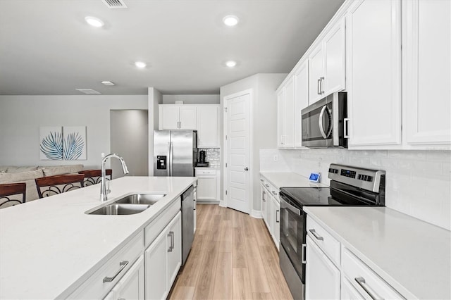 44325 Saddlewood Ct, Punta Gorda, FL 33982 - kitchen featuring stainless steel appliances, light countertops, white cabinets, backsplash, and recessed lighting
