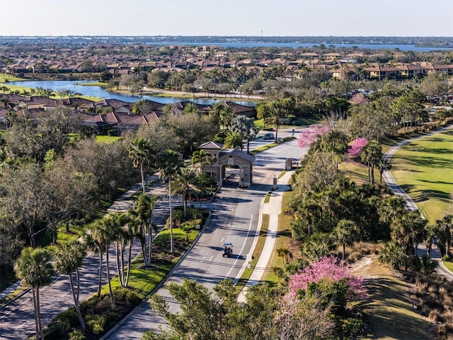 drone / aerial view with a residential view and a water view