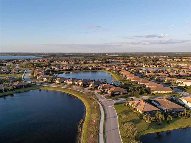 birds eye view of property with a water view and a residential view