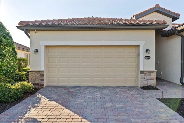 garage featuring decorative driveway