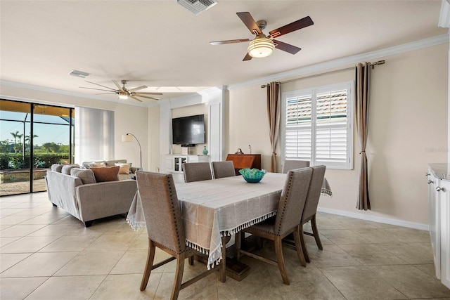 dining room with baseboards, visible vents, and ornamental molding