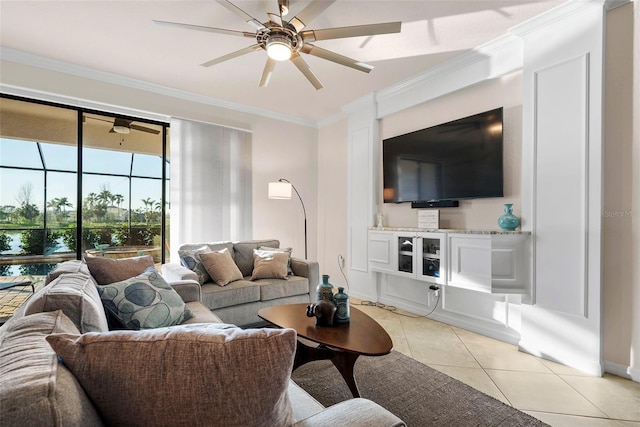 living room featuring light tile patterned floors, a sunroom, a ceiling fan, and crown molding