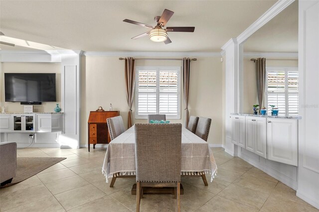 dining room with light tile patterned floors, plenty of natural light, a ceiling fan, and crown molding
