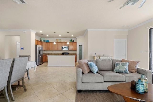 living room with light tile patterned floors, visible vents, crown molding, and recessed lighting