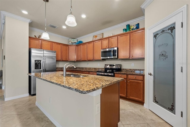 kitchen with visible vents, dark stone countertops, stainless steel appliances, crown molding, and a sink