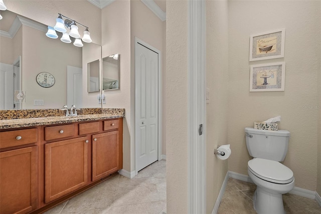 bathroom with toilet, vanity, baseboards, ornamental molding, and tile patterned floors