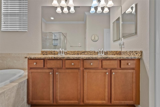 full bath with double vanity, a garden tub, crown molding, a shower stall, and a sink