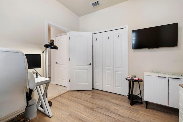 office space featuring visible vents and light wood-style flooring