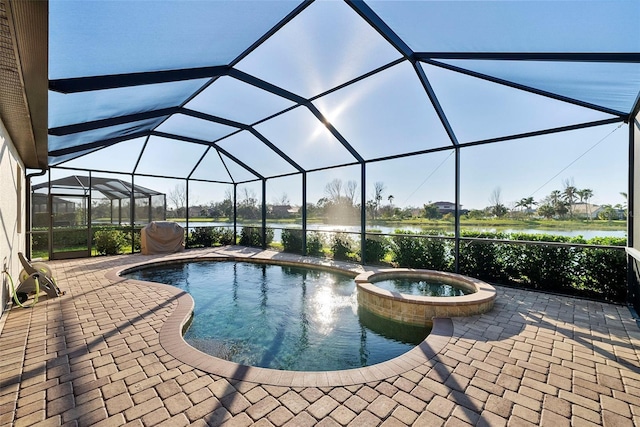 view of pool featuring a lanai, a patio area, and a pool with connected hot tub