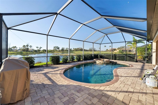pool with a patio, a water view, a grill, and glass enclosure