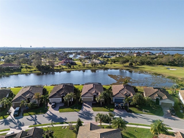 birds eye view of property with a water view and a residential view