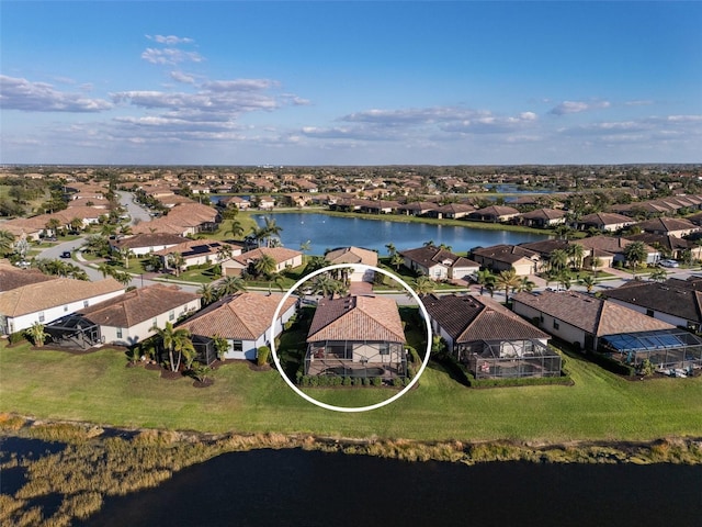 bird's eye view featuring a water view and a residential view