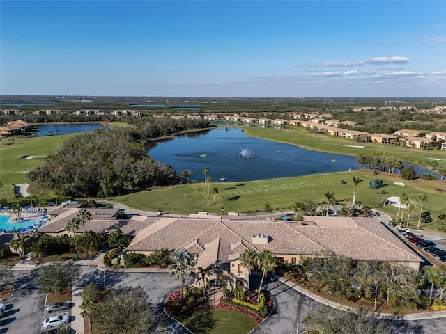 birds eye view of property with a water view and view of golf course