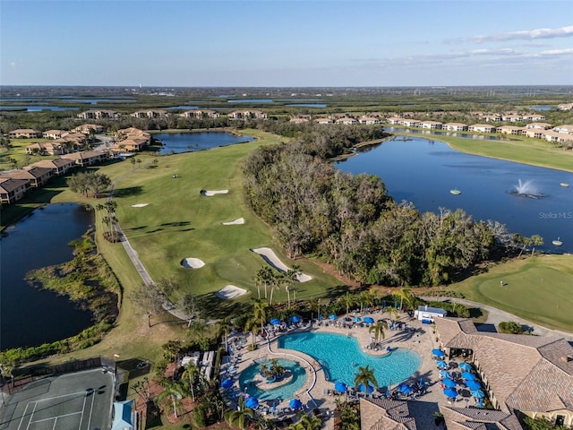 birds eye view of property with a water view and golf course view