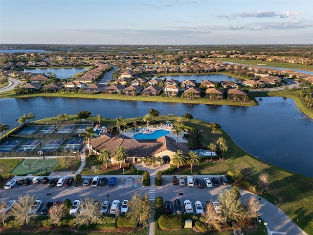 birds eye view of property with a water view and a residential view