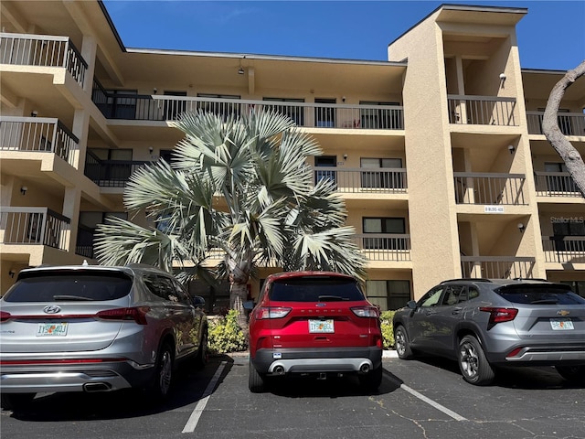 view of building exterior featuring uncovered parking