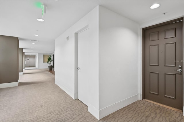 hall featuring recessed lighting, carpet flooring, and baseboards