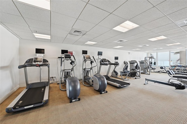 gym featuring baseboards, visible vents, a drop ceiling, and carpet flooring