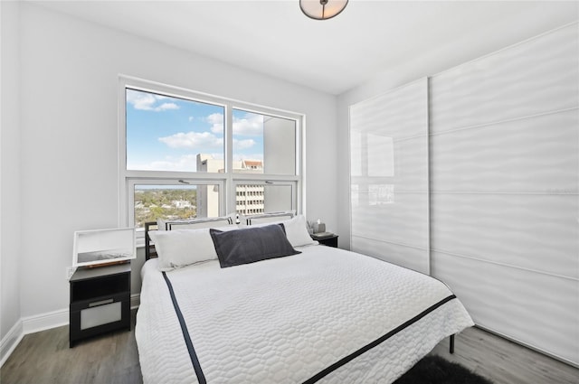 bedroom featuring wood finished floors and baseboards