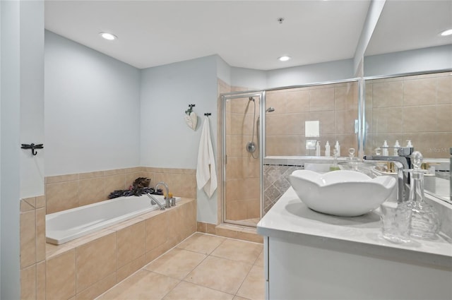 full bath featuring a garden tub, tile patterned flooring, vanity, and a shower stall