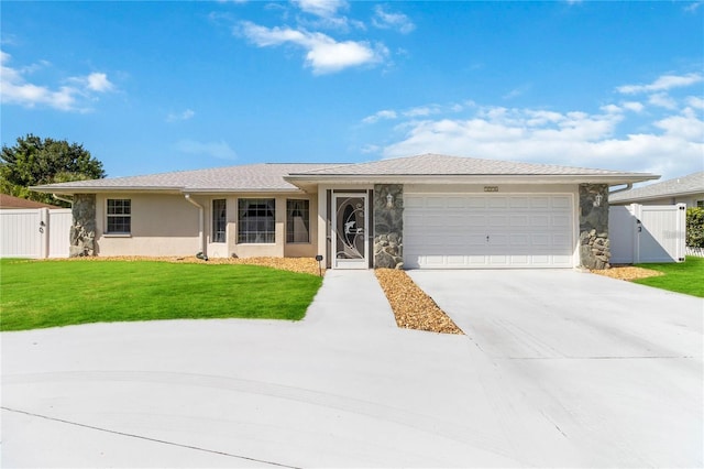 single story home featuring a garage and a front yard