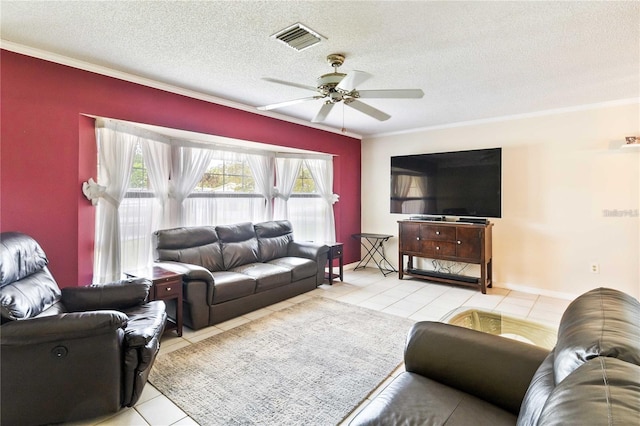 tiled living room featuring ceiling fan, crown molding, and a textured ceiling