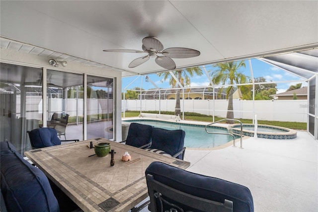 view of swimming pool featuring an in ground hot tub, ceiling fan, a lanai, and a patio