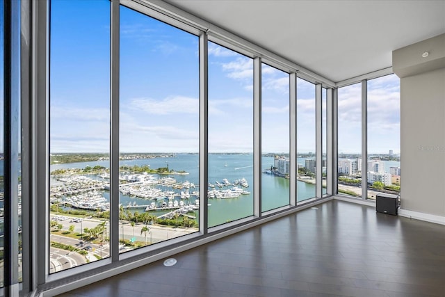 1155 N Gulfstream Ave Unit 1709, Sarasota, FL 34236 - spare room featuring view of marina, a water view, wood finished floors, and a wall of windows