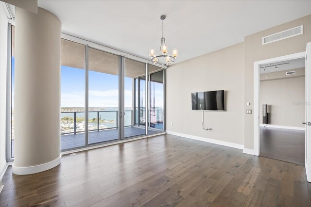 1155 N Gulfstream Ave Unit 1709, Sarasota, FL 34236 - unfurnished living room with floor to ceiling windows, dark wood-style floors, and a chandelier